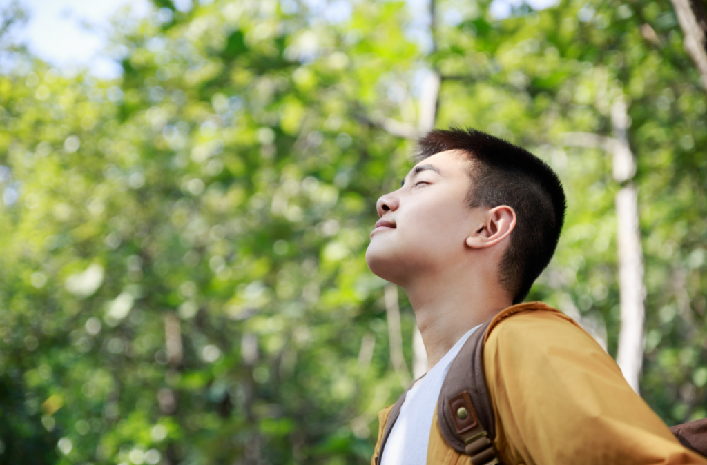 Teenager breathing in a forest